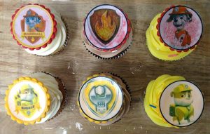 cupcakes topped with various edible images