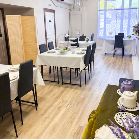 four-seat-tables The Eat My Sweets Bakery event space set restaurant style with four seat table arrangements